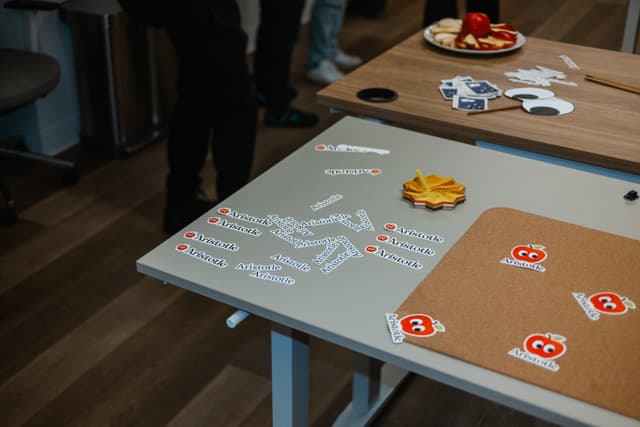 Aristotle stickers and swag on a table