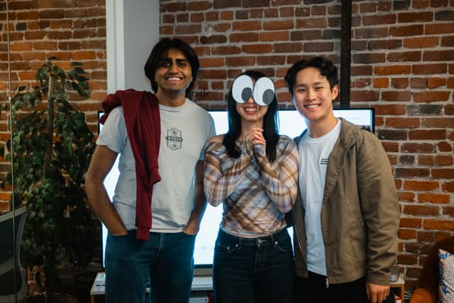 Three team members posing together