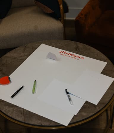 Attendance sheet and pens on a table