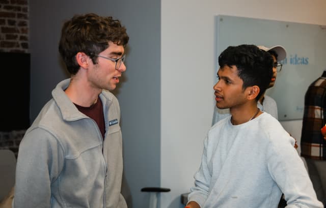 Two fellows chatting in the office