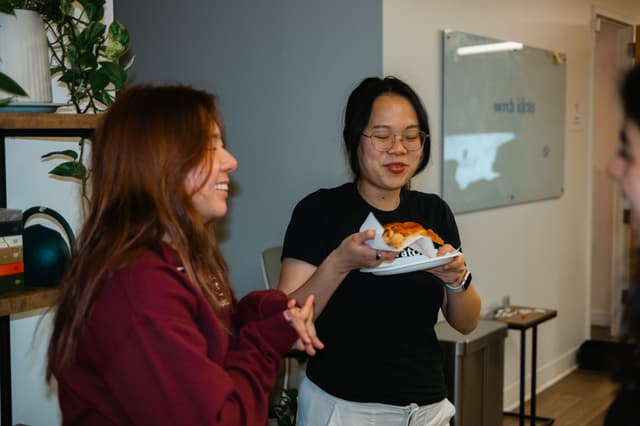 Fellows laughing and sharing pizza
